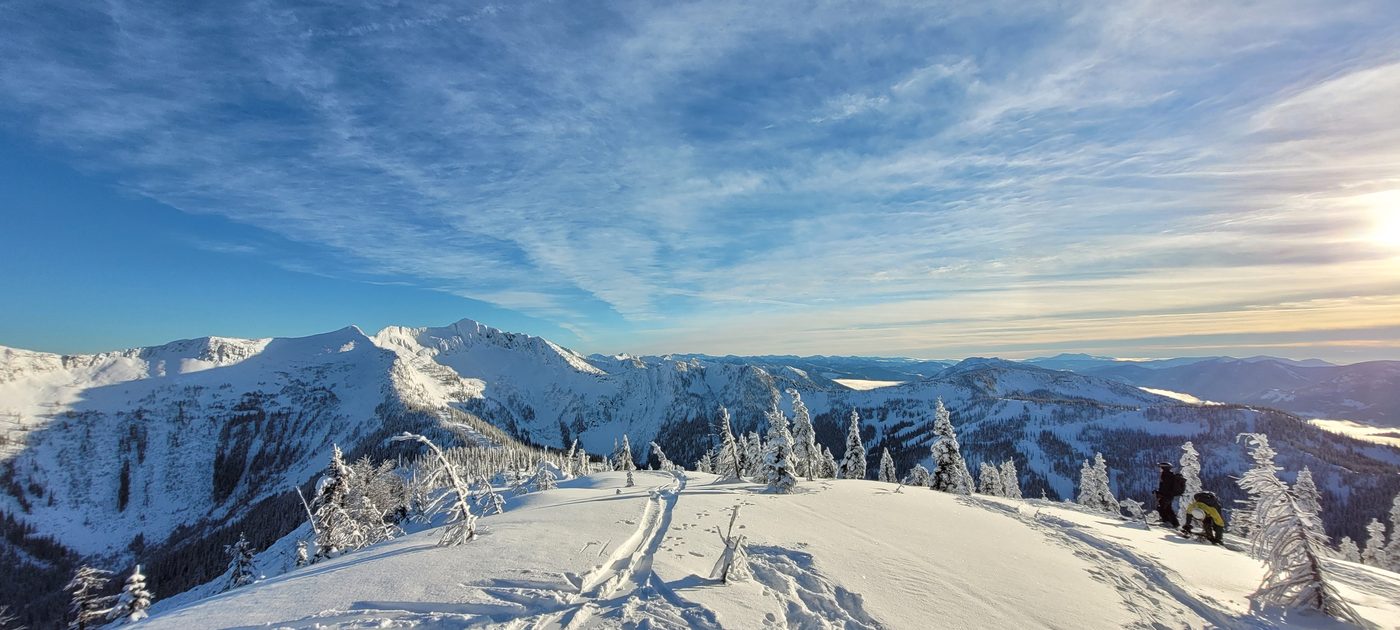 Snow-covered mountain ridges under a blue sky