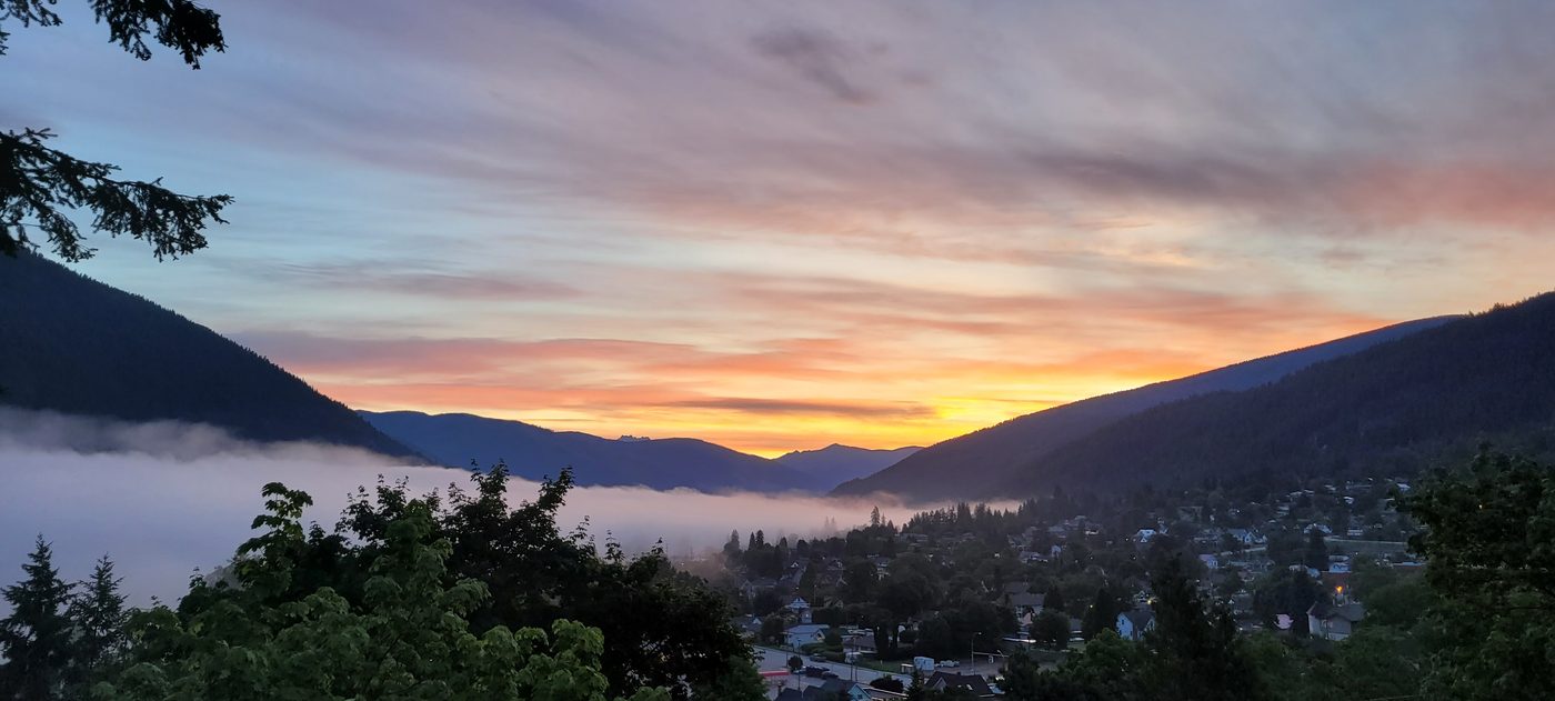 Sunrise over Nelson and the West Arm of Kootenay Lake, with fog in the valley